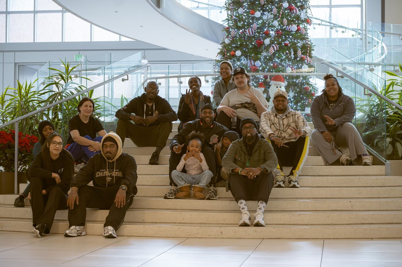 Group photo on stairs by a Christmas tree