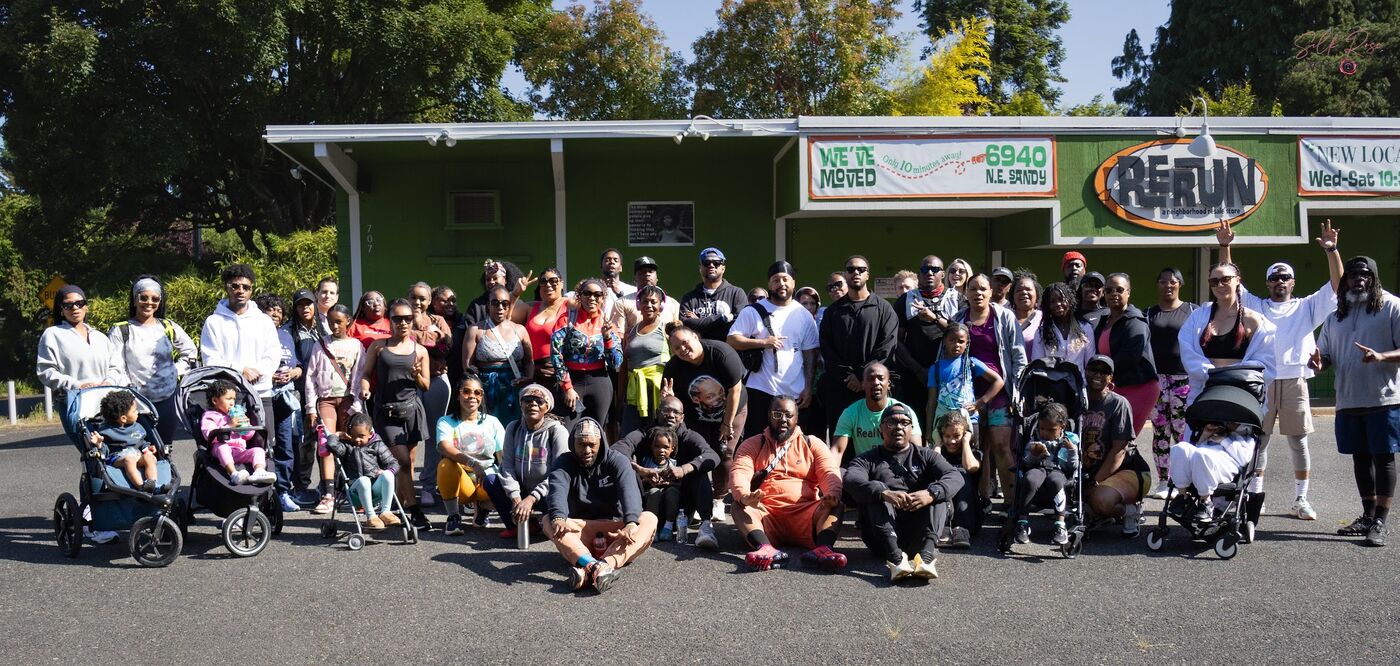 Large group photo outside a neighborhood resale store